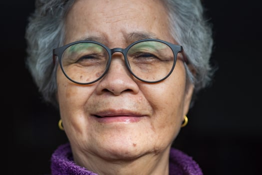 Close-up of face senior woman smile and wearing glasses. photo