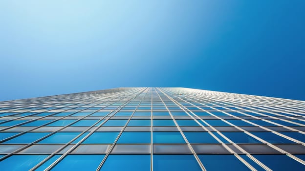 Tall Building With Lots of Windows Against a Blue Sky photo