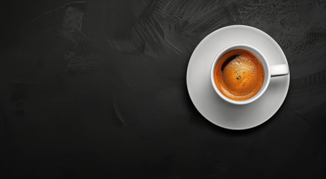 A Cup of Coffee on a Saucer on a Black Table photo