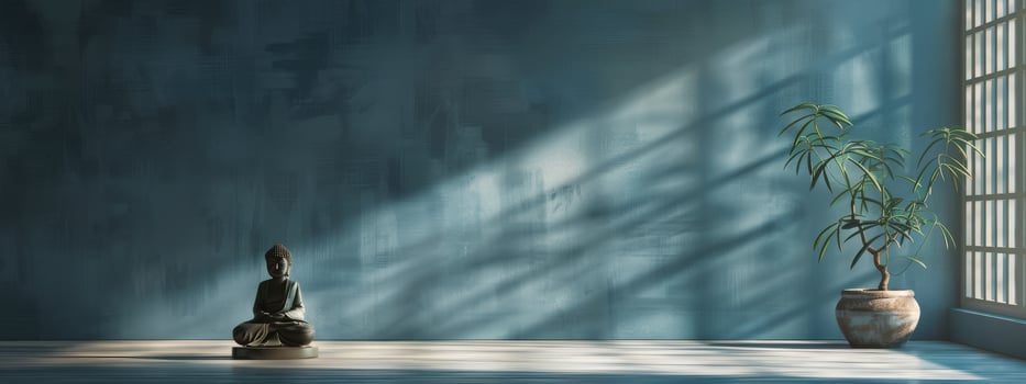 Buddha Statue Sitting in Room With Blue Walls photo