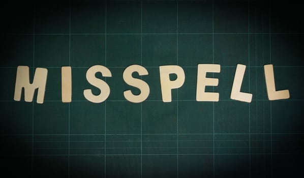 misspell word on green cutting board photo