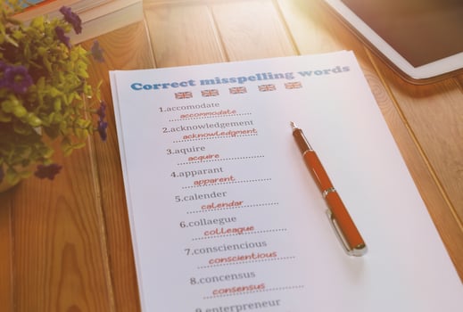 English misspelling worksheet with pen and tablet photo