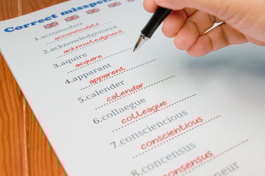 English misspelling worksheet with pen and tablet photo
