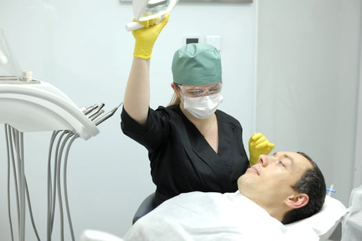 inflatable pillow for dental chair patient raises head doctor puts pillow on him comfortable comfortable dental treatment anesthesia relaxation latest equipment inflating space on pillow balls inside photo