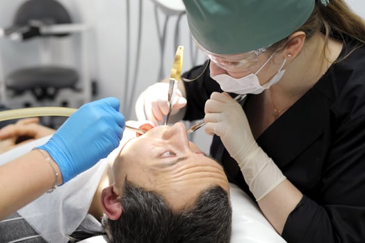 pull a tooth out adult man praying with his eyes looks at the doctor who tears his tooth dentistry hurts the request of a man woman photo