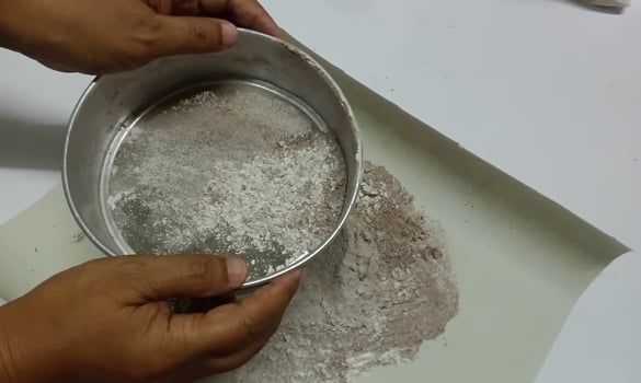 Sift flour and cocoa and use to make dessert photo
