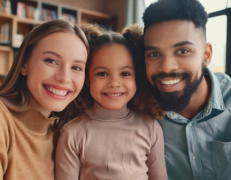 Smiling Together. Young Multiracial Parents with Happy Biracial Girl photo
