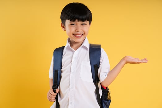 Portrait of adorable asian boy posing on yellow background photo