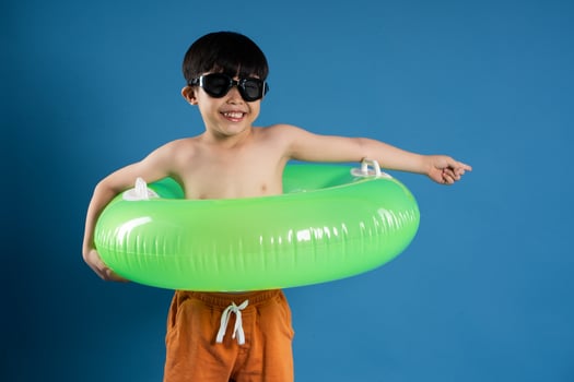 Portrait of asian boy posing on blue background photo