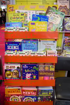 New Delhi, India, February 17 2024 - Variety of Books on shelf inside a book-stall at Delhi International Book Fair, Selection of books on display in Annual Book Fair at Bharat Mandapam complex photo