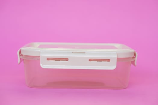 Empty transparent boxes, containers. Pink background. Concept, kitchenware use for contains food as lunch box or keep fresh of food in refrigerator. Cleanable, reusable. photo