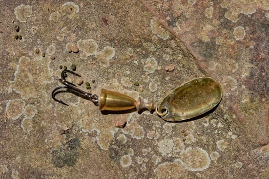 Fishing lure on a rock photo