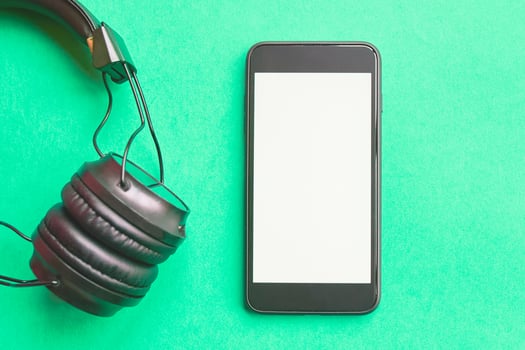 Headphones and smartphone on colorful background. Flat lay concept. headphones and telephone on green pastel backgrounds. photo