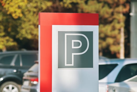 Parking sign. Signal on a car and tree background. photo