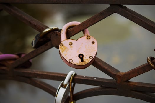 Red heart shape padlock on the fence of the bridge. Concept Padlocks Love forever. Valentines day or wedding day. photo