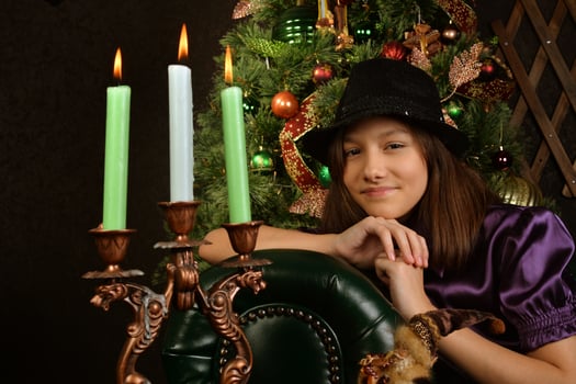 Pretty little girl looking on fire of candles photo