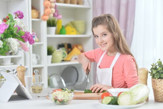 Portrait of young girl cooking in kitchen photo