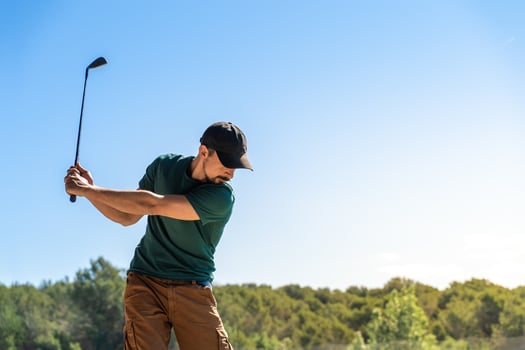 Young man playing golf in summer. Lifestyle game. Healthy and sporty outdoors. Concentration skills concept. photo