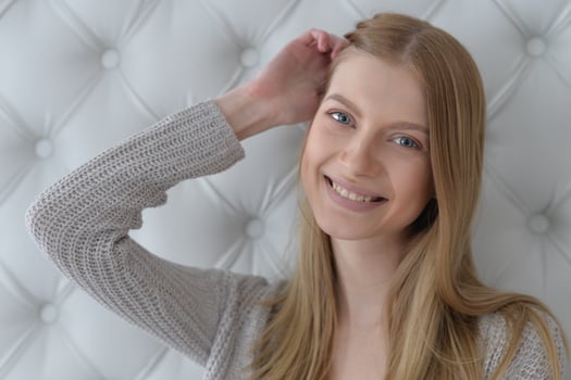 Beauty portrait. Young woman on grey wall background. photo