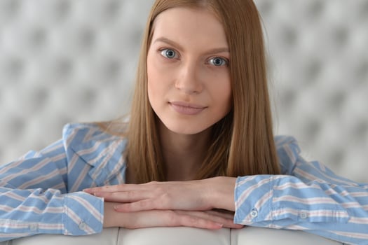 Beauty portrait. Young woman on grey wall background. photo