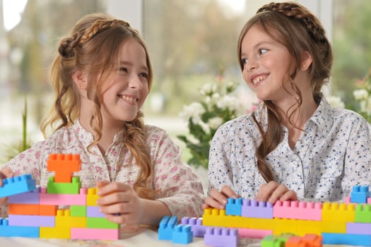 Beautiful girls with colorful blocks at home photo