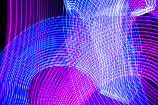 Futuristic abstract neon blue light stripes on black background. photo