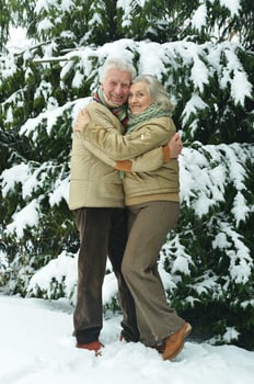 Happy senior couple at snowy winter park. photo