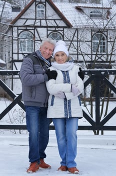 Happy senior couple at snowy winter park. photo