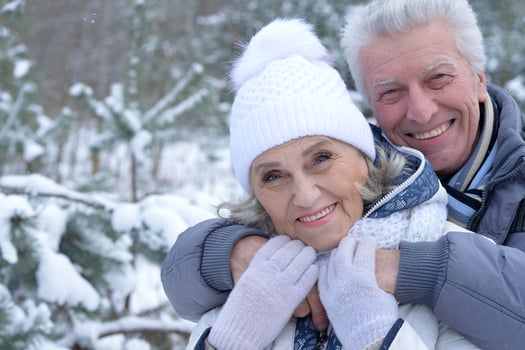 Happy senior couple walking in winter outdoors photo