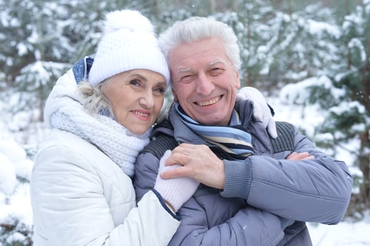 Happy senior couple walking in winter outdoors photo