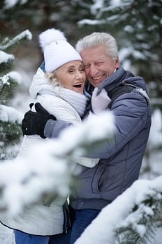 Happy senior couple walking in winter outdoors photo