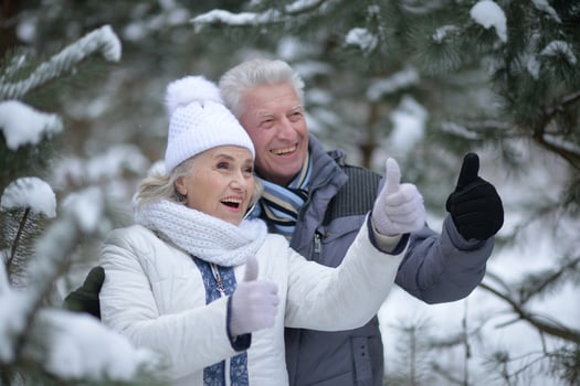 Happy senior couple walking in winter outdoors photo