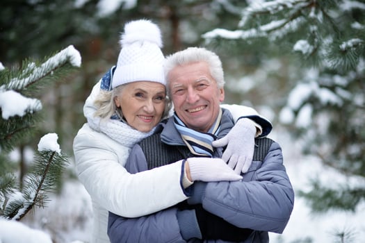 Happy senior couple walking in winter outdoors photo