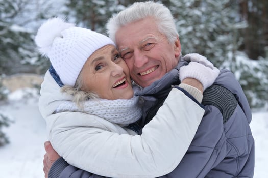 Happy senior couple walking in winter outdoors photo