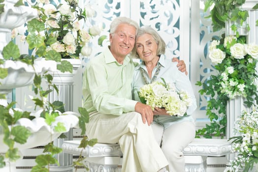 Happy beautiful senior couple posing together at home photo