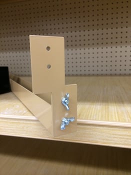 A Metal Fixture Component on a Shelf photo