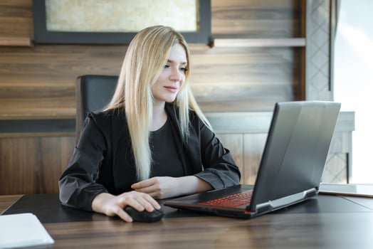 Young female teacher is sitting in front of laptop conducting lesson, concept of online teaching. photo