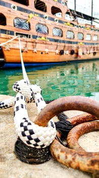 Symbol of Safety, Large Old Ship Moored at Dock with Mooring Knot, Close-Up. photo