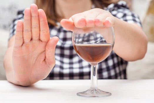 Young woman refused alcohol drink. Concept of alcoholism. Womans alcoholism photo