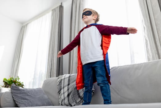 Child in Superhero Costume Playing at Home photo