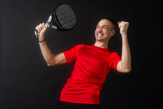 Professional monitor of paddel holding a black racket. Man paddel player playing a match. photo