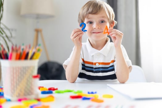 Young Boy Learning Shapes During Homeschooling Session photo