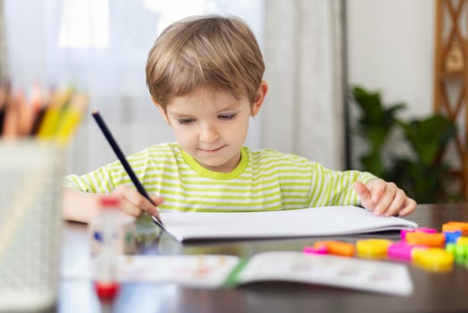Young Boy Focused on Painting at Home - Creative Childhood Development photo