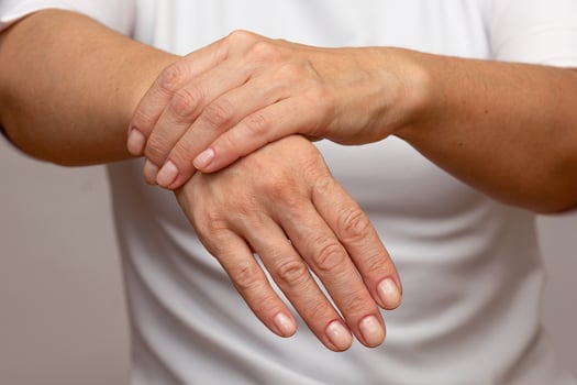 Woman hands showing right wrist pain photo