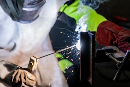 Industry worker welding a pieces of metal in the factory, weld concept photo