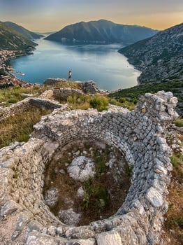 Woman Walking among Ruins of Ancient Fortress photo