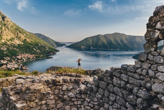 Woman Standing among Ruins of Ancient Fortress photo