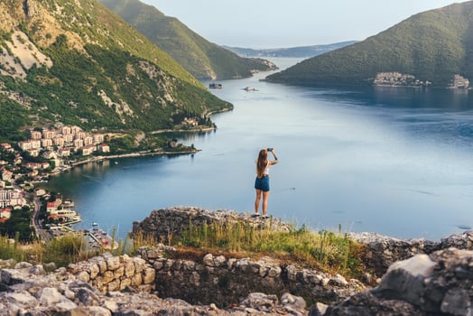 Woman Taking Photo among Ancient Ruins