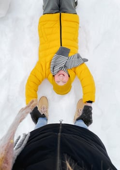 Top View on Laughing Kid Lying on Snow photo