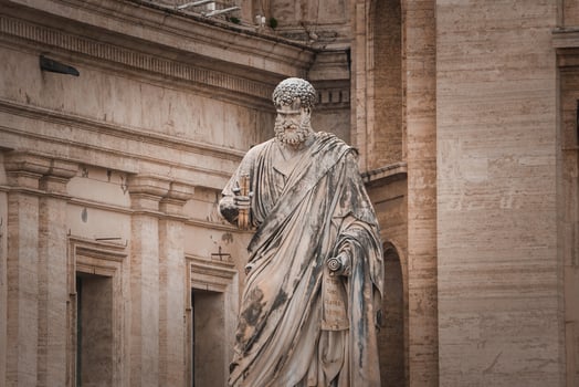 Ancient stone statue of bearded figure with scroll in Vatican City. photo